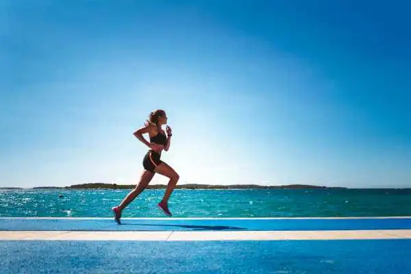 Woman running showing strong leg muscle Isle of Isla